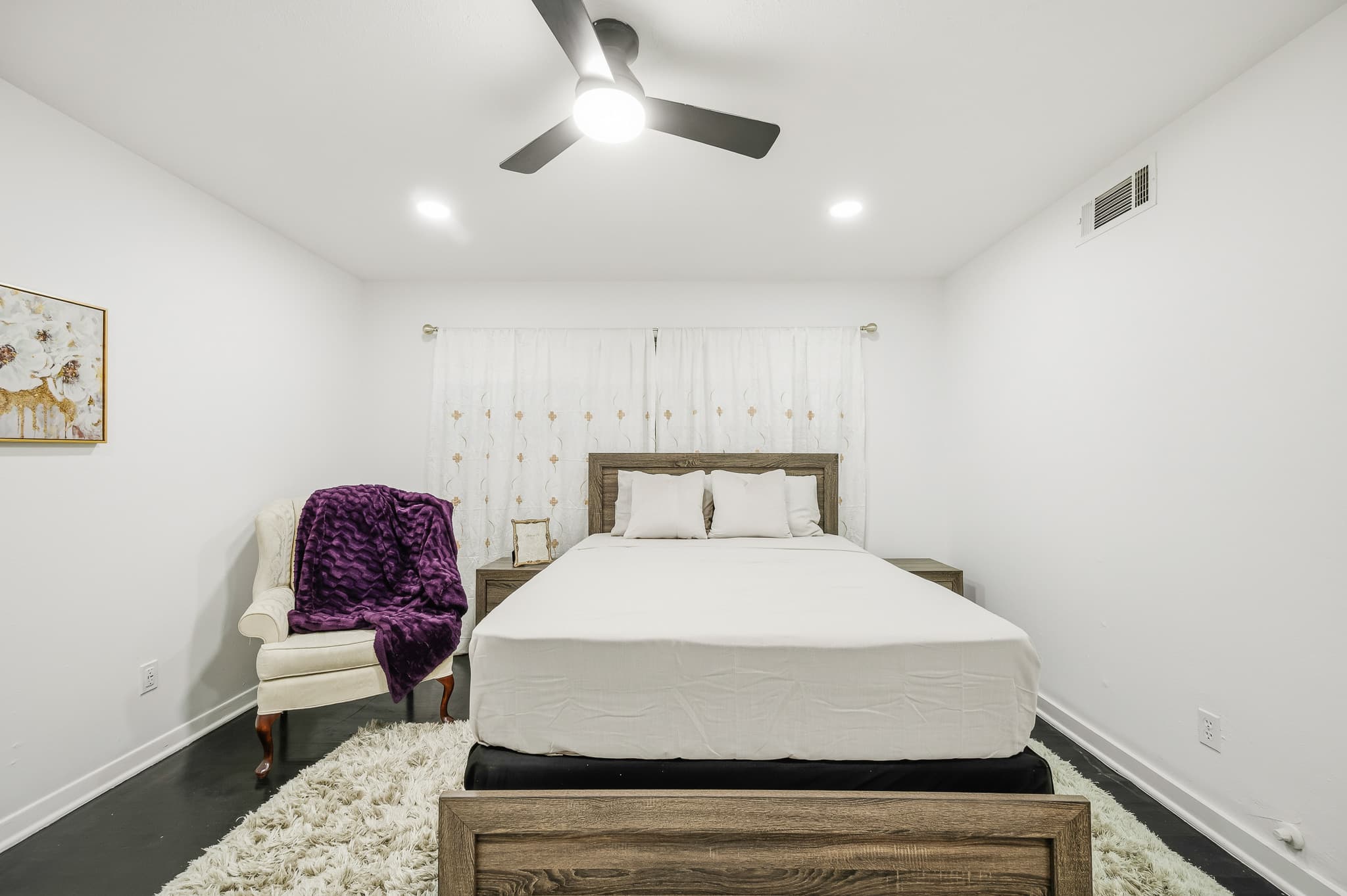 Primary bedroom with a wooden bed frame
